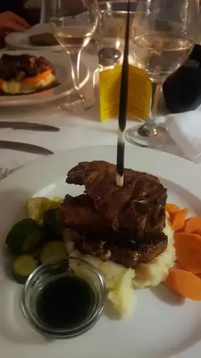 a plate of food with meat and vegetables on a table at Kleineweide Boutique Estate in Pretoria