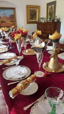a table with plates and glasses on a red table cloth at Kleineweide Boutique Estate in Pretoria