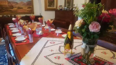 a dining room table with flowers in a vase at Kleineweide Boutique Estate in Pretoria