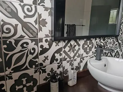 a bathroom with a sink and a mirror at Boh- House in Graskop