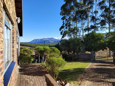 a porch of a house with a view of the mountains at Boh- House in Graskop