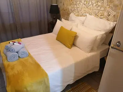 a bed with towels and pillows on it at Boh- House in Graskop