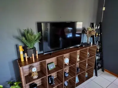 a flat screen tv sitting on top of a entertainment center at Boh- House in Graskop