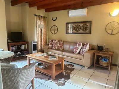 a living room with a couch and a table at The Bush Hut in Hoedspruit