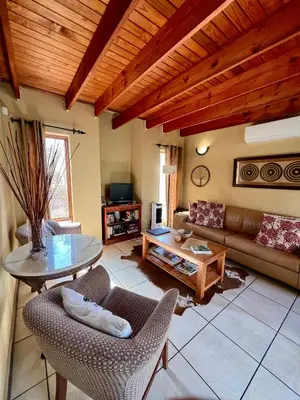 a living room with a couch and a table at The Bush Hut in Hoedspruit