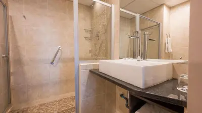 a bathroom with a sink and a shower at ANEW Hotel Hatfield Pretoria in Pretoria
