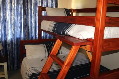 a couple of bunk beds in a room at OPPIBERG GUEST HOUSE and SPA in Hartbeespoort
