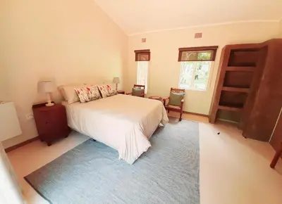 a bedroom with a white bed and a window at Echo Caves in Ohrigstad