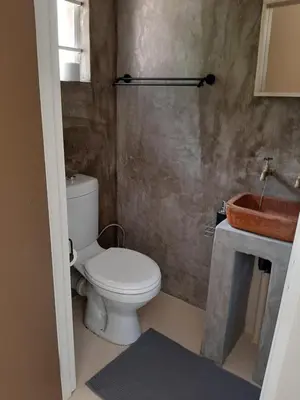a bathroom with a toilet and a sink at Echo Caves in Ohrigstad