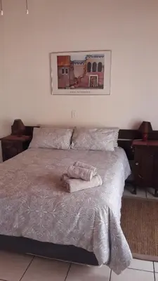 a bedroom with a bed with a towel on it at Echo Caves in Ohrigstad