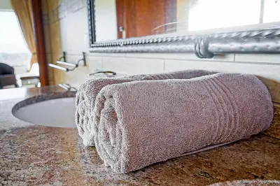 a bathroom with a sink and a towel on a counter at Zebula 8 Bedroom Lodge – IV1 in Mabula
