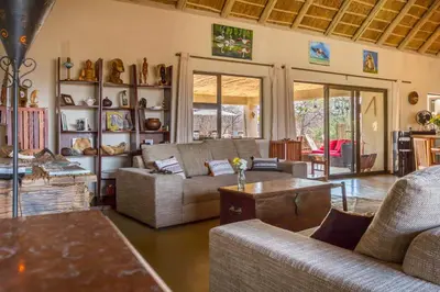 a living room with a couch and a table at Ukuthula Bush Lodge in Hoedspruit