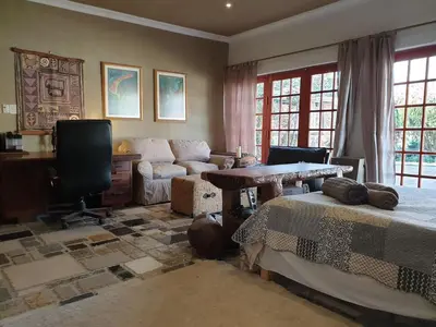 a living room with two beds and a table at Rockscape in Sandown
