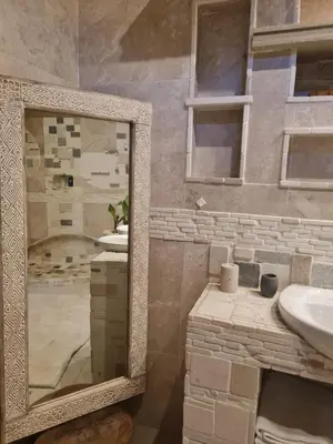 a bathroom with two sinks and a large mirror at Rockscape in Sandown