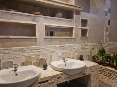 a bathroom with two white sinks on a counter at Rockscape in Sandown