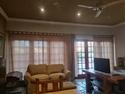 a living room with a couch and a tv at Rockscape in Sandown