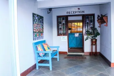 a blue chair sitting in front of a door at Villa Jana Guesthouse in Pretoria