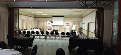 a banquet hall with black chairs and tables in it at Villa Jana Guesthouse in Pretoria