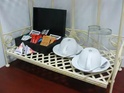 a tea set on a tea rack withacersacers at Villa Jana Guesthouse in Pretoria