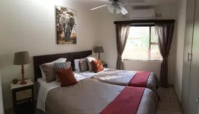 a bedroom with a bed and a window at Villa Danamara in Phalaborwa