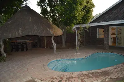 a small swimming pool in front of a house at Villa Danamara in Phalaborwa