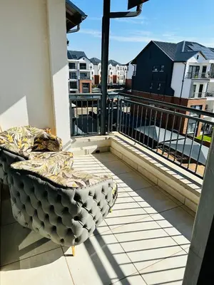 a balcony with a bed and a view of buildings at The Blyde, an impeccable blissful getaway (Balwin properties) in Pretoria