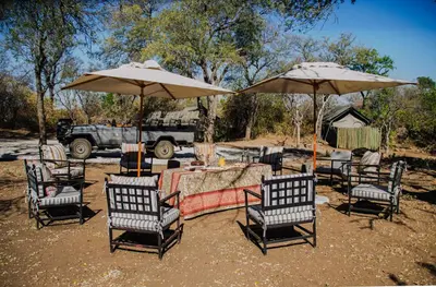 a group of chairs and tables with umbrellas at Abelana Safari Camp in Phalaborwa