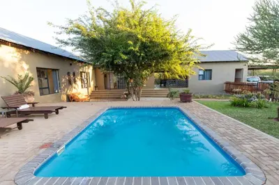 a swimming pool in the backyard of a house at Asuite-Dream in Hoedspruit