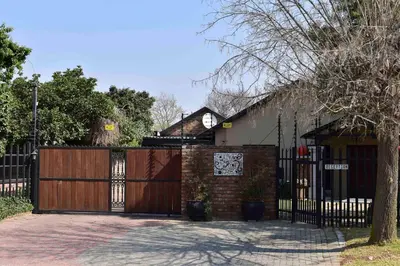 a house with a wooden gate and a fence at 13 Hobson in Secunda