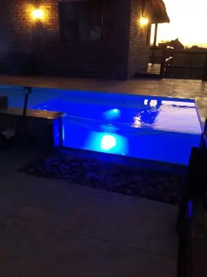 a pool with blue lighting in a backyard at night at Kubu Khaya Mabalingwe in Mabula