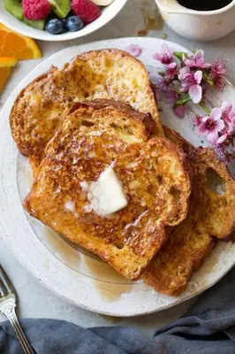 two pieces of toast on a plate with butter at Kubu Khaya Mabalingwe in Mabula