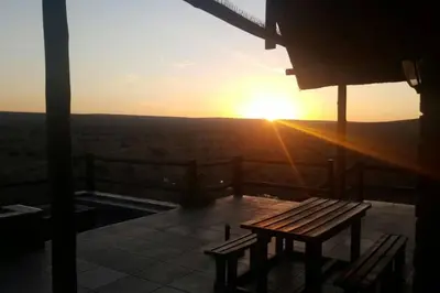 a sunset from the top of a building with a bench at Kubu Khaya Mabalingwe in Mabula