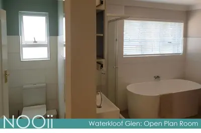 a bathroom with a tub and a toilet and a window at NOOii Open Plan Room in Pretoria