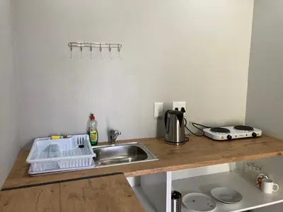 a small kitchen with a sink and a counter top at Halleria Self Catering in White River