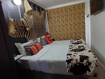 a bedroom with a bed with zebra heads on the wall at Wooden Creek Estate in Kempton Park