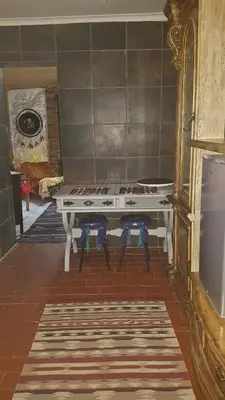 a kitchen with a stove and two stools at Wooden Creek Estate in Kempton Park