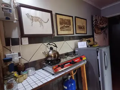 a kitchen with a stove with a tea kettle on it at Wooden Creek Estate in Kempton Park