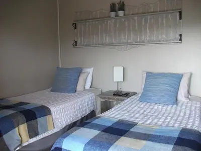 two beds sitting next to each other in a room at Meerkat Manor in Komatipoort