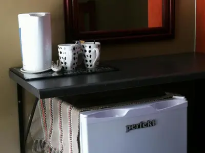 a table with three cups on top of a refrigerator at Meerkat Manor in Komatipoort