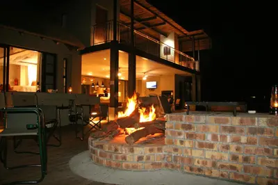 a brick fire pit in a patio at night at Jacana River Lodge Mjejane Game Reserve in Hectorspruit