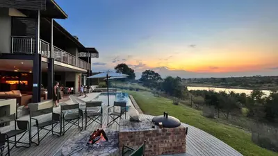 an outdoor patio with a fire pit and a sunset at Jacana River Lodge Mjejane Game Reserve in Hectorspruit