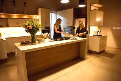 two women standing in a kitchen preparing food at Jacana River Lodge Mjejane Game Reserve in Hectorspruit