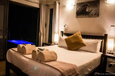 a bedroom with a bed with two towels on it at Lindanda Luxury Lodge in Hoedspruit