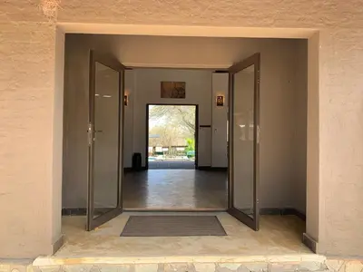 an open door into a room with a hallway at Lindanda Luxury Lodge in Hoedspruit
