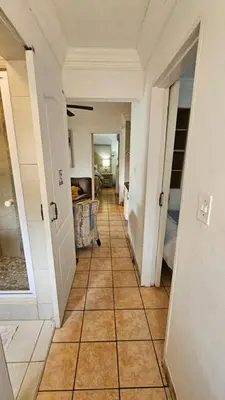 a hallway with a tile floor in a house at Pont de Fleur in Hartbeespoort