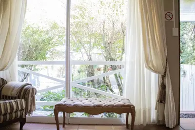 a window with a bench in front of it at Panda's Guest Cottages in Kaapsehoop