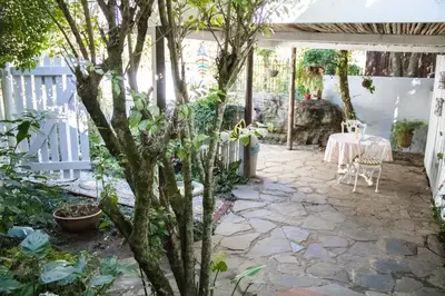 a patio with a table and a fence at Panda's Guest Cottages in Kaapsehoop