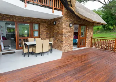a patio with a table and chairs on a deck at Kruger Park Lodge Unit No. 608A in Hazyview