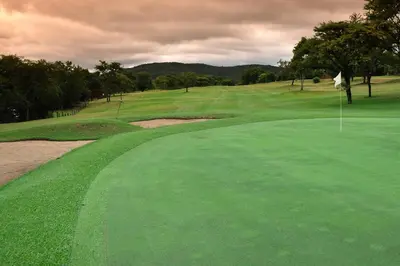 a view of a golf course with a green at Kruger Park Lodge Unit No. 608A in Hazyview