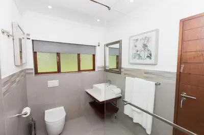 a white bathroom with a sink and a toilet at Kruger Park Lodge Unit No. 608A in Hazyview